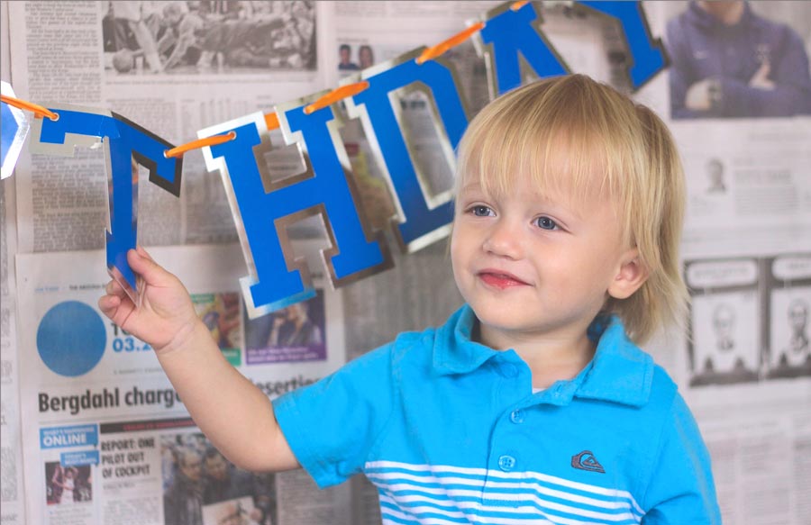 touching the letter "t" on birthday sign for diy kid's picture ideas for the terrible twos customer background creations by danielle jacqueline photography in olive branch mississippi