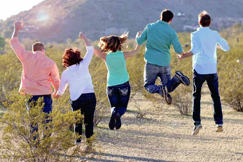 family of 4 with son's finace photography tips by danielle jacqueline photography color coordination and jeans during golden hour north mississippi