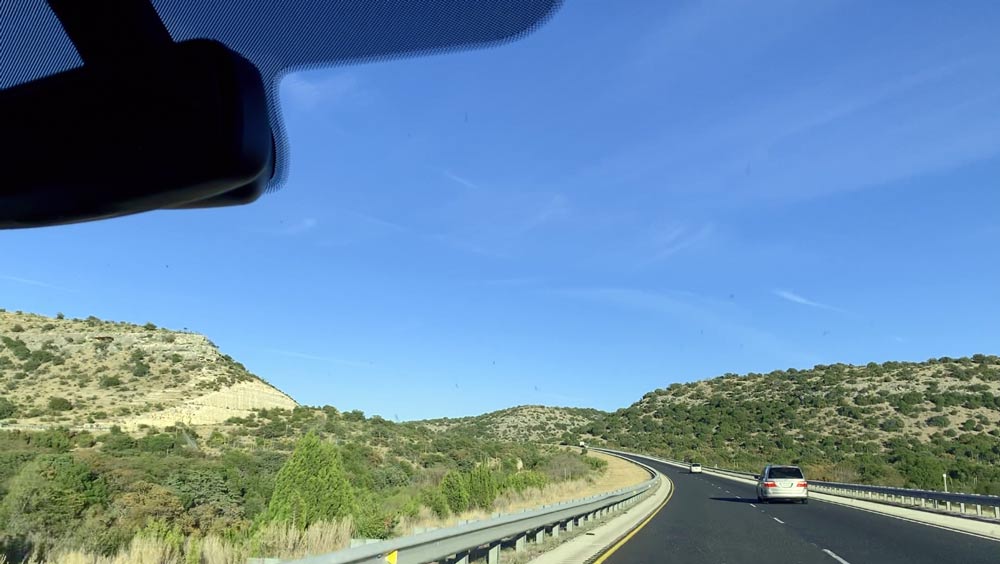 angled road out of desert for family vacation roadtrip by trasks on their way to grandmas for thanksgiving short story by photographer travel tips