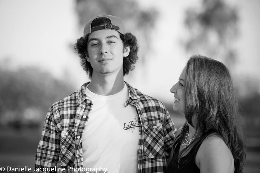 proud mother with her son during high school senior portraits with danielle jacqueline spotlight black and white