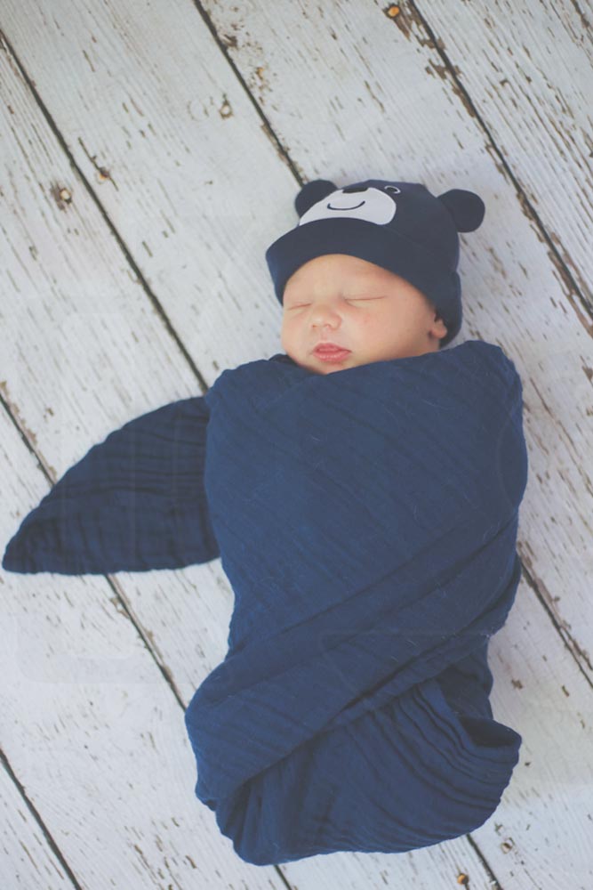 heaven portrait baby boy blue beanie and blanket white washed wooden flooring photography studio new arrivals desoto county mississippi