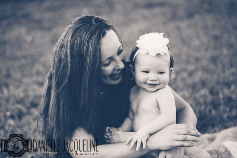 mother and daughter photography for baby's first birthday in northern mississippi with danielle jacqueline photography black and white candid moment big natural smiles