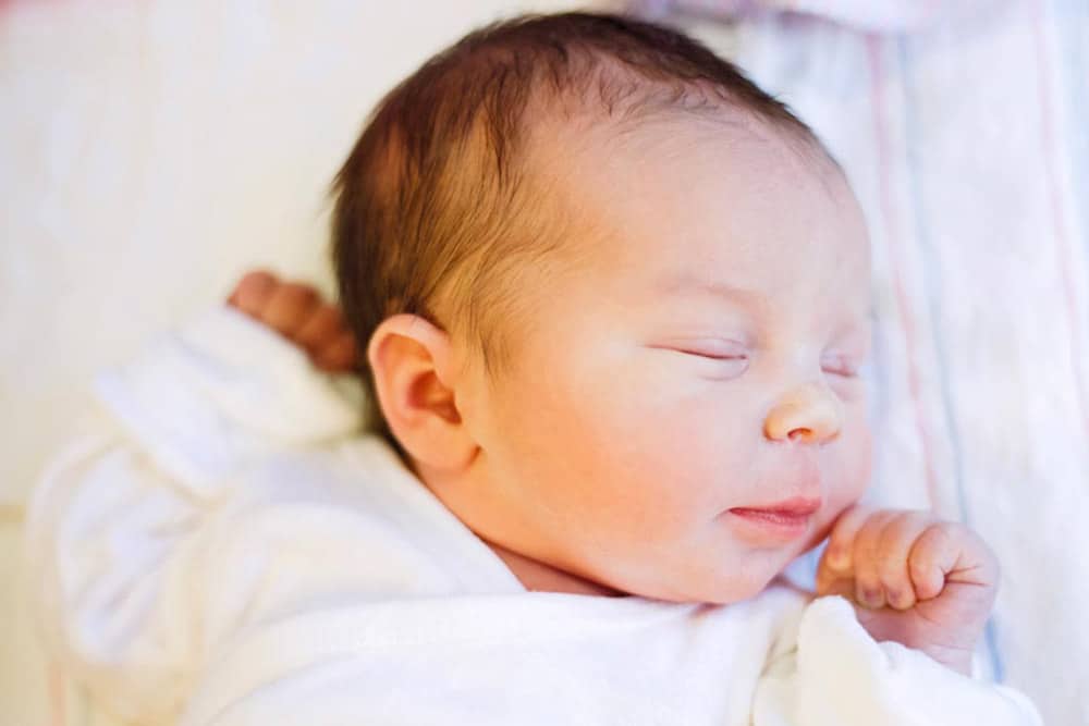 close up of newly born baby girl laying in incubator in hospital recovery room during fresh 48 session with danielle jacqueline photography in desoto county ms