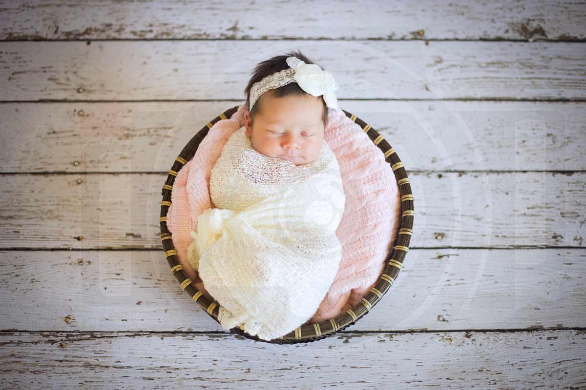 adorable little infant daughter of danielle jacqueline photograpjy client with white wooden flooring at studio in olive branch mississippi professional