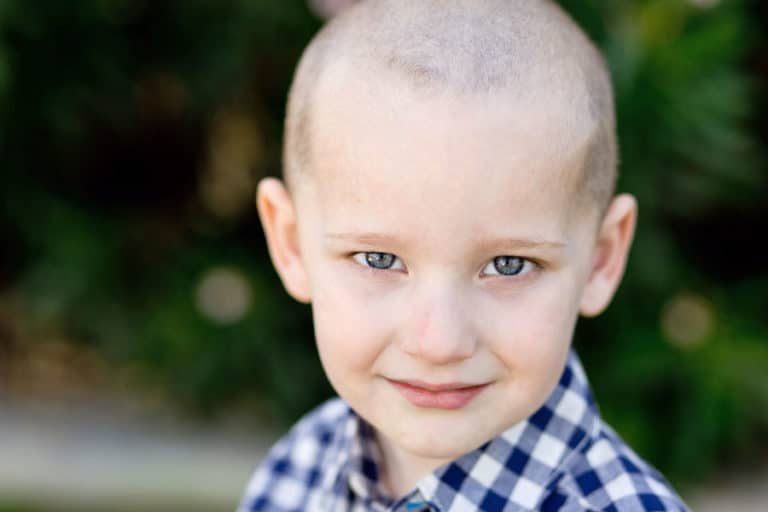 personal portraits for parents of elementary students in memphis tennessee by danielle jacqueline photography young boy looking at camera half smile checkered shirt