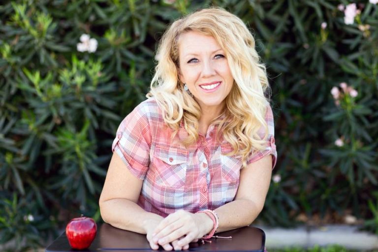 headshot profile picture for preschool teacher seated in children's desk outside kindergarden class with danielle jacqueline photography for website in desoto county ms