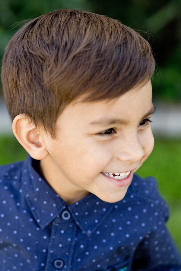 side view of laughing young preschool boy dressed nice for class pictures outside for yearbook by danielle jacqueline photography south of memphis tennessee