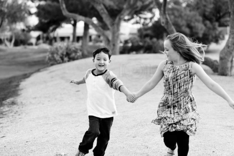 park day with family young boy acting up but sibling captured helping encourage him to participate in session with danielle jacqueline photography near memphis tennessee