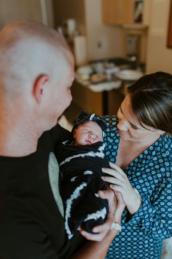 mom and dad enjoying first child in the hospital together with photographer near memphis danielle jacqueline