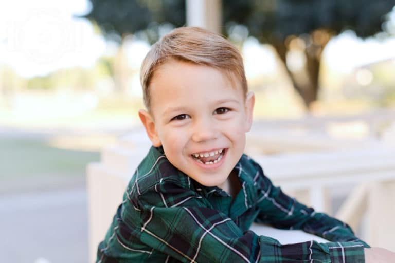 center focus of 5 year old son for parent's holiday portraits in december at park outside by danielle jacqueline photography