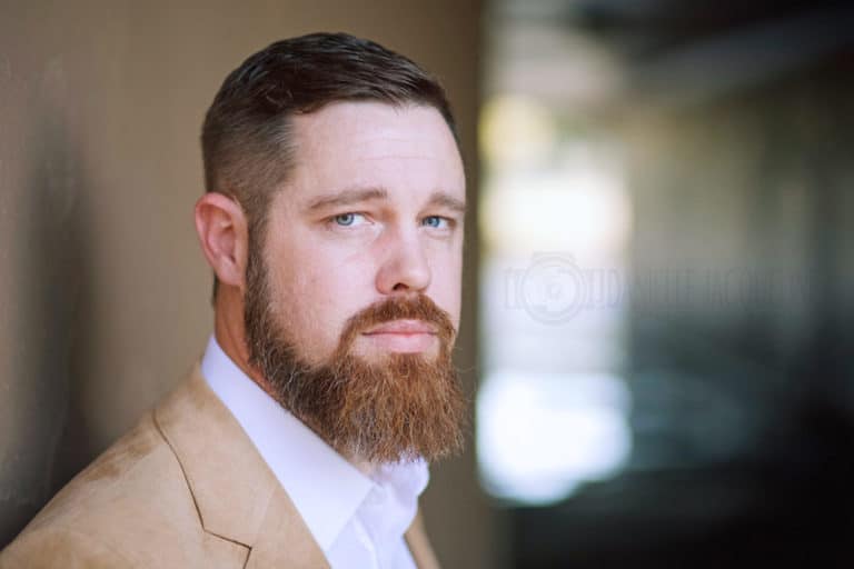 close up headshot image for entrepreneur in northern mississippi with tunnel in background tan suit and beard by danielle jacqueline photography in olive branch ms