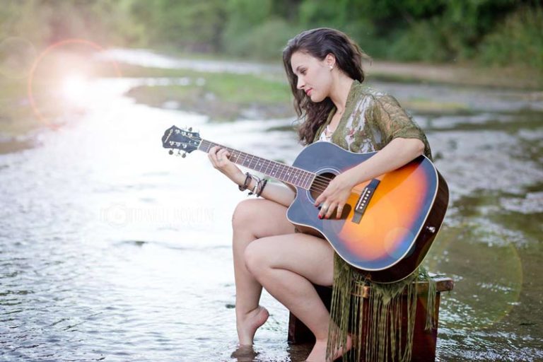 playing the guitar in the middle of delta stream for senior portraits in memphis Tennessee unique girl pictures by danielle jacqueline photography future song writer