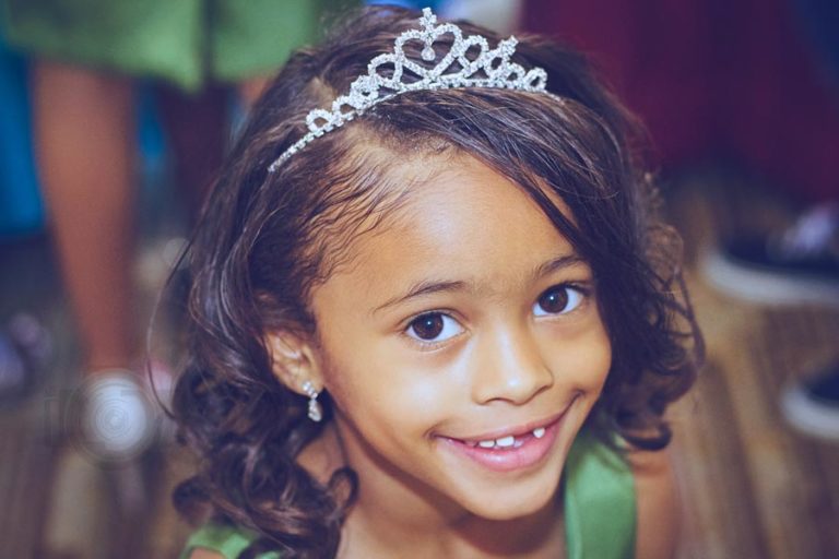 center of attention during birthday wearing crown 7 year old light green dinner dress hair done photography session to capture the memories in olive branch mississippi and memphis area by danielle jacqueline