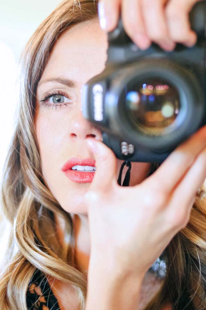 close up headshot of danielle trask from danielle jacqueline photography where lens reflection and flare are showcased alongside beautiful woman with serious look as successful entrepreneur in memphis tn