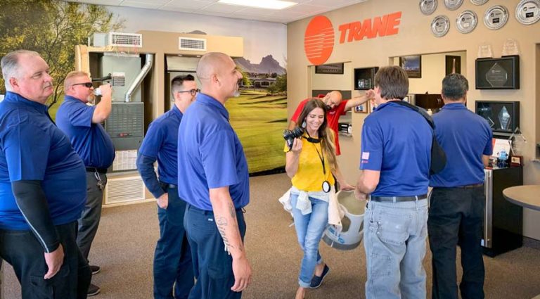 about danielle jacqueline photography walking through group of business clients during photoshoot in olive branch mississippi for corporate headshots