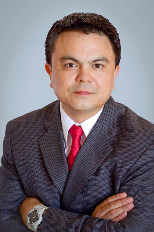 red tie suited attorney headshot with solid backdrop by danielle jacqueline photography in olive branch ms business