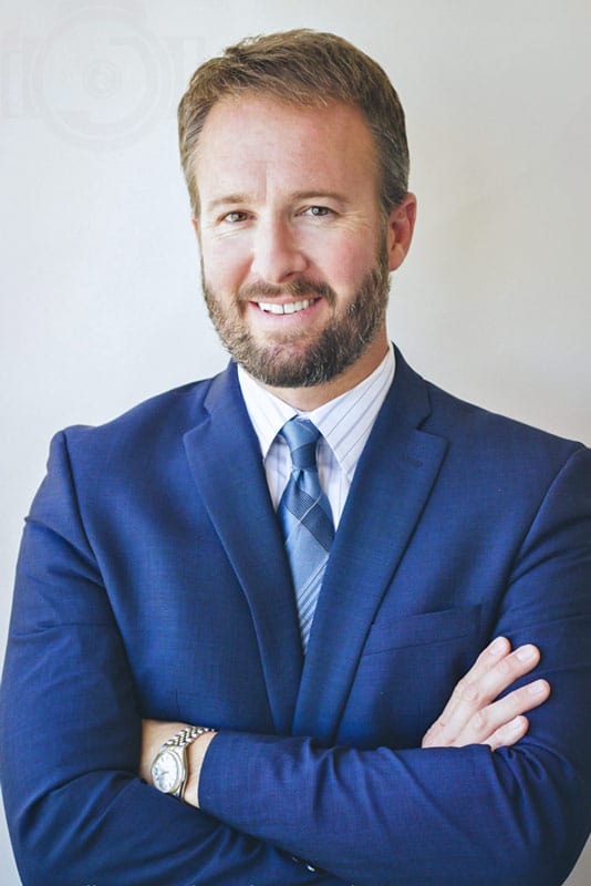 blue suit short beard big smile memphis businessman arms crossed for headshot photography session at danielle jacqueline's studio in olive branch ms