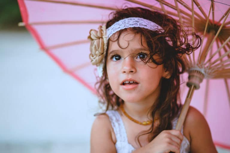 pretty pink umbrella with flower headband little girl curly brown hair professional portraits by danielle jacqueline olive branch services in mississippi creative direction