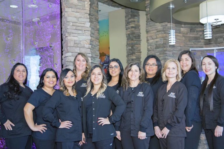 row of female dental assistants standing in waiting room at major pediatric practice captured by danielle jacqueline photography in olive branch mississippi