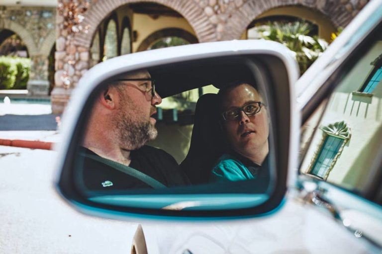 cool photograph of business partners arguing in car over big money decision captured in rear view mirror or tesla suv door entrepreneurs in action images for podcast local desoto county image services