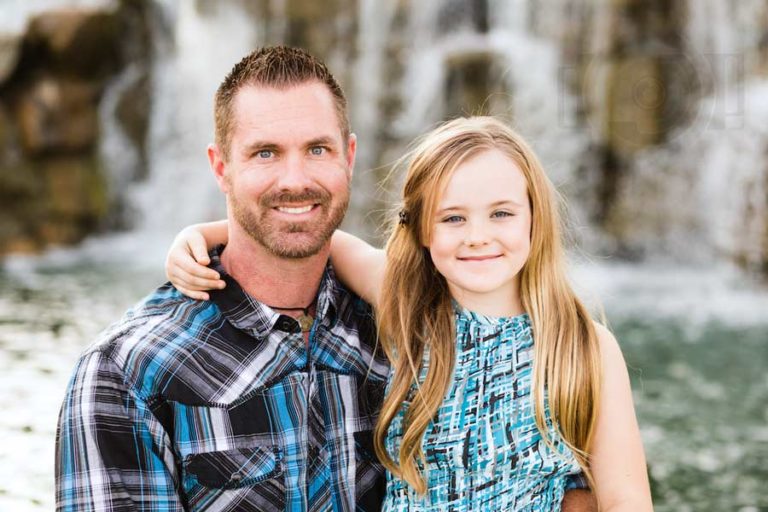 simple facing daughter and daddy picture during family session in front of natural landscape turquise dress and plaid flannel 5 o clock shadow by danielle jacqueline blue theme