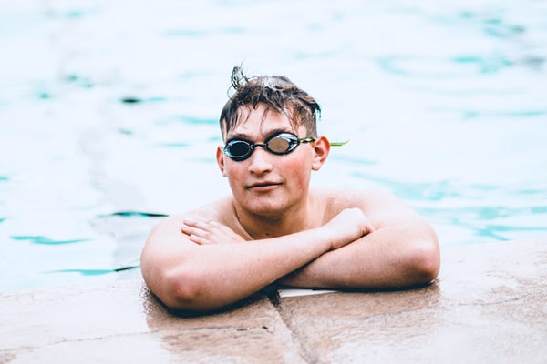 athena b parent of son in photograph reviews photographer in olive branch ms for son's senior portrait graduation photos in water during swimming photoshoot for school goggles on hair messy goofy look