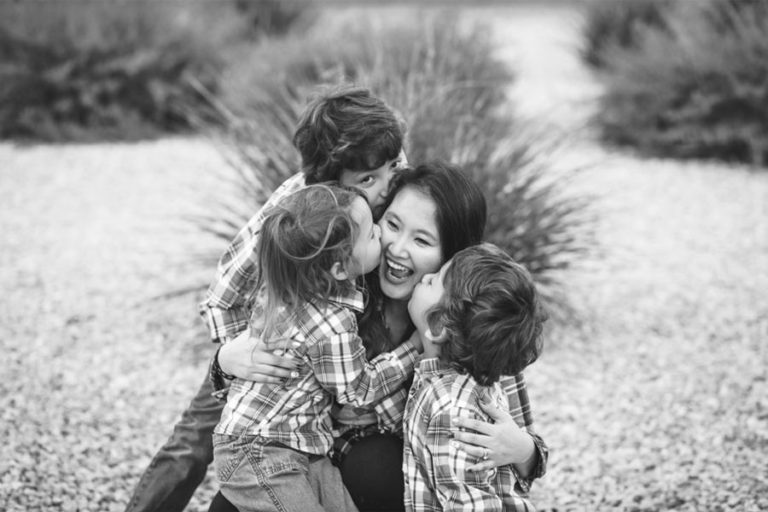 everyone jump on mommy kids swarming parent in backyard during family portrait session with danielle jacqueline out of olive branch ms black and white photos culture