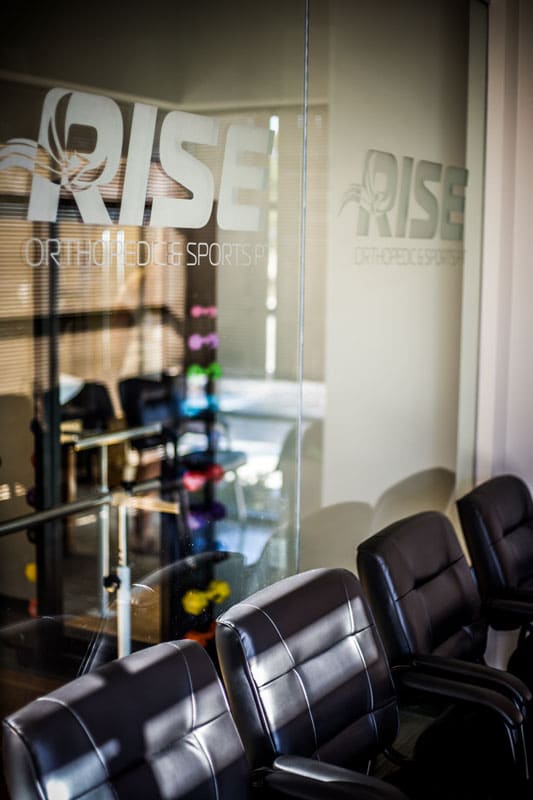 entrace of physical therapy location hand weights through glass company logo walking station for rehab by small business photographer danielle jacqueline