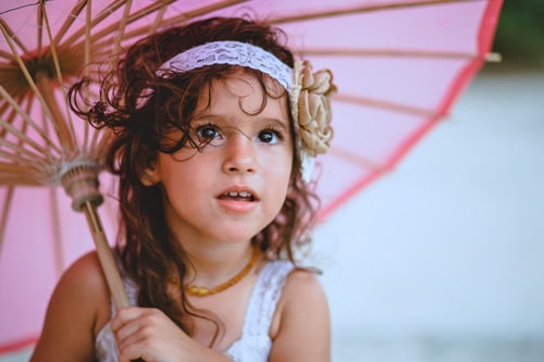 pink umbrella over little princess daughter in white for kid's portraits in memphis tennessee by danielle jacqueline photography parent left reviews super happy cuteness