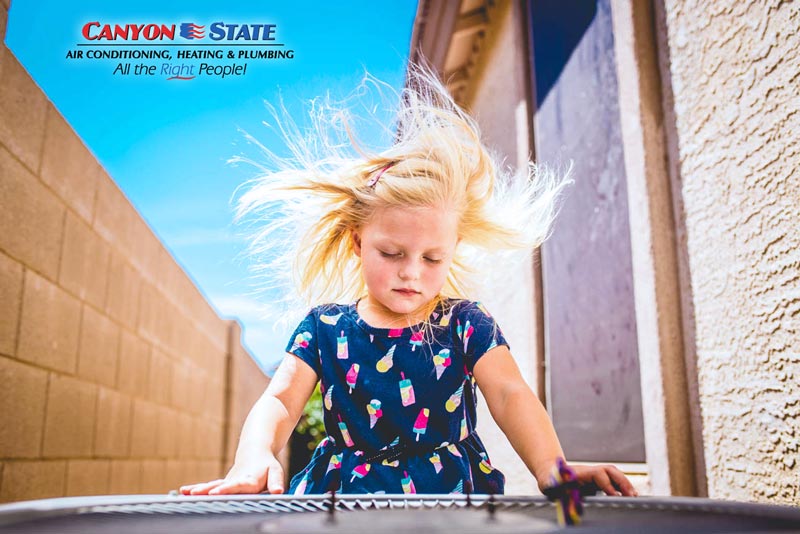 air conditioning unit outside on side of house with little girl hair blowing in fan hot mississippi day needing local hvac company advertisement photographer danielle jacqueline in desoto county also serving memphis