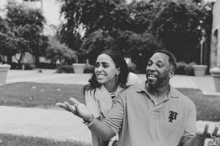 graduating senior girl enjoying time with father during end of high school photoshoot outdoors with danielle jacqueline black and white image southeast memphis tn