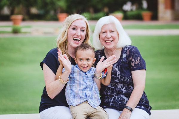 little boy on mommys lap during park photoshoot session with large family in memphis tennessee grandma too grass in background sitting on bench give raving danielle jacqueline photography review