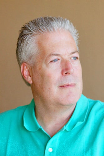 grey haired spiked polo shirt teal brown background looking off to the right professional profile pictures for businessman in memphis tn by danielle jacqueline photography reviews