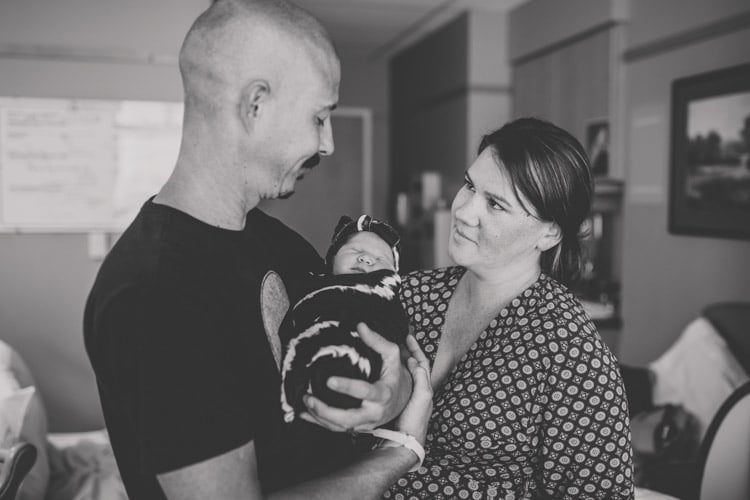 mom and dad having a moment now that maternal process is over and baby has arrived in desoto county photography by danielle jacqueline black and white new families