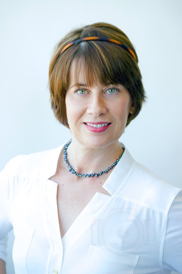 clear high quality image of female entrepreneur in white teal necklace during headshot portrait studio session with danielle jacqueline photography in memphis tn