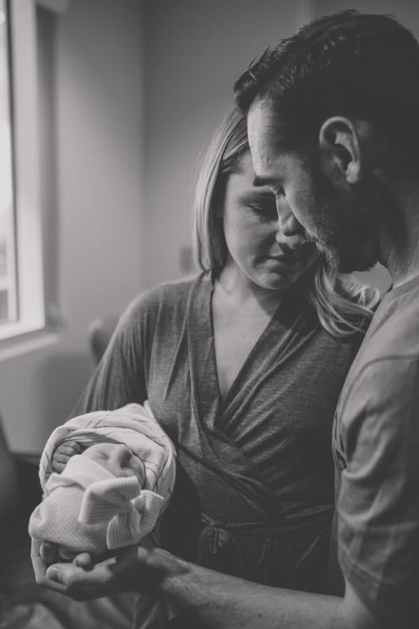 in love parents mississippi olive branch candid moment after birth of child with each other in hospital room black and white beautiful by danielle jacqueline photography