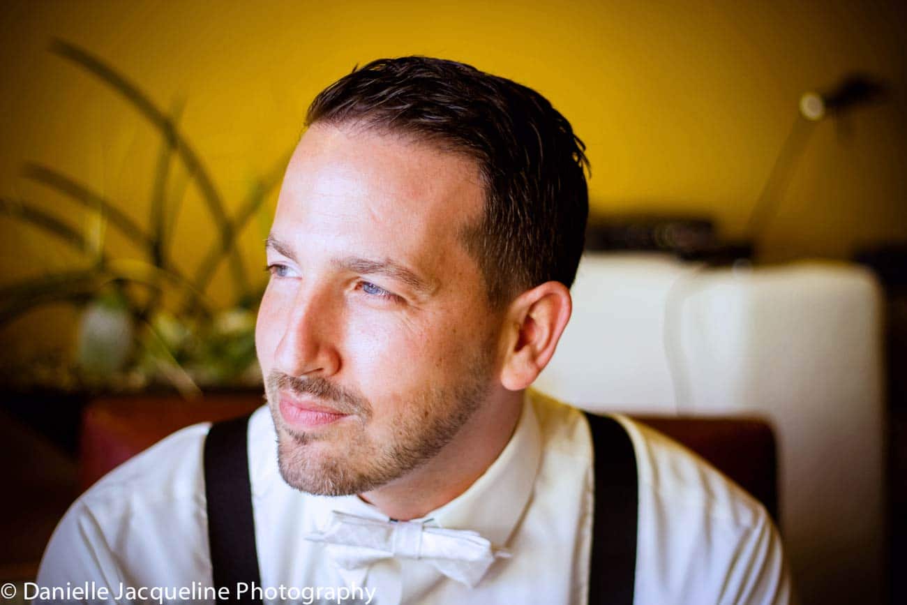 pre wedding portrait of groom in luxury suite in desoto county before bride appeared in wedding gown for the first time captured by danielle jacqueline photography