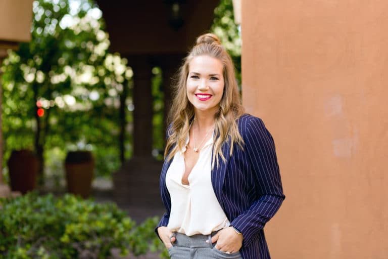 lifestyle portraits outdoors at work wearing formal attire strong women of business low cut blouse next to building hands on belt loops by danielle jacqueline head shot photography