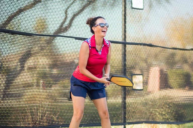 competitive tennis league team pictures action shots on court wearing red shirt new racquet smiling enjoying the game captured by professional sports photographer danielle jacqueline in desoto county ms