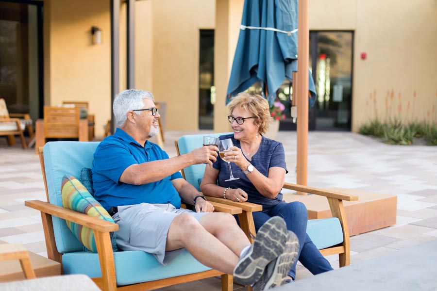 dating couple at senior retirement community where indoor photographer was taking pictures of the facility with models from resort during lunch having drinks back patio area memphis tn