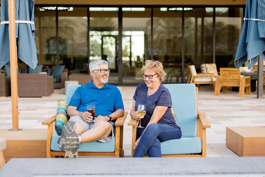 husband and wife enjoying retired life outdoors at resort like assisted living for business photography session with danielle jacqueline in memphis tennessee