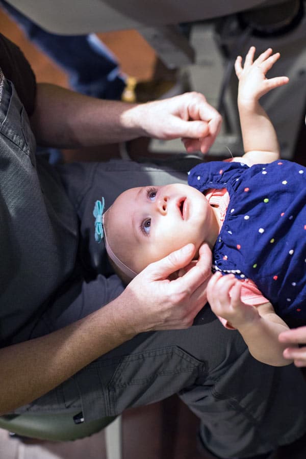 dentist treating infant on lap at pediatric clinic calm and relaxed photo by danielle jacqueline in olive branch mississippi