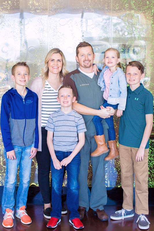 company photos with family for pediatric dentistry office with 5 locations in front of bubble wall by danielle jacqueline photography near memphis tn