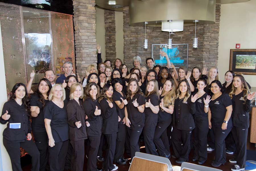 company photo standing on lobby seating at dentistry location for website pictures by danielle jacqueline photography near memphis tn