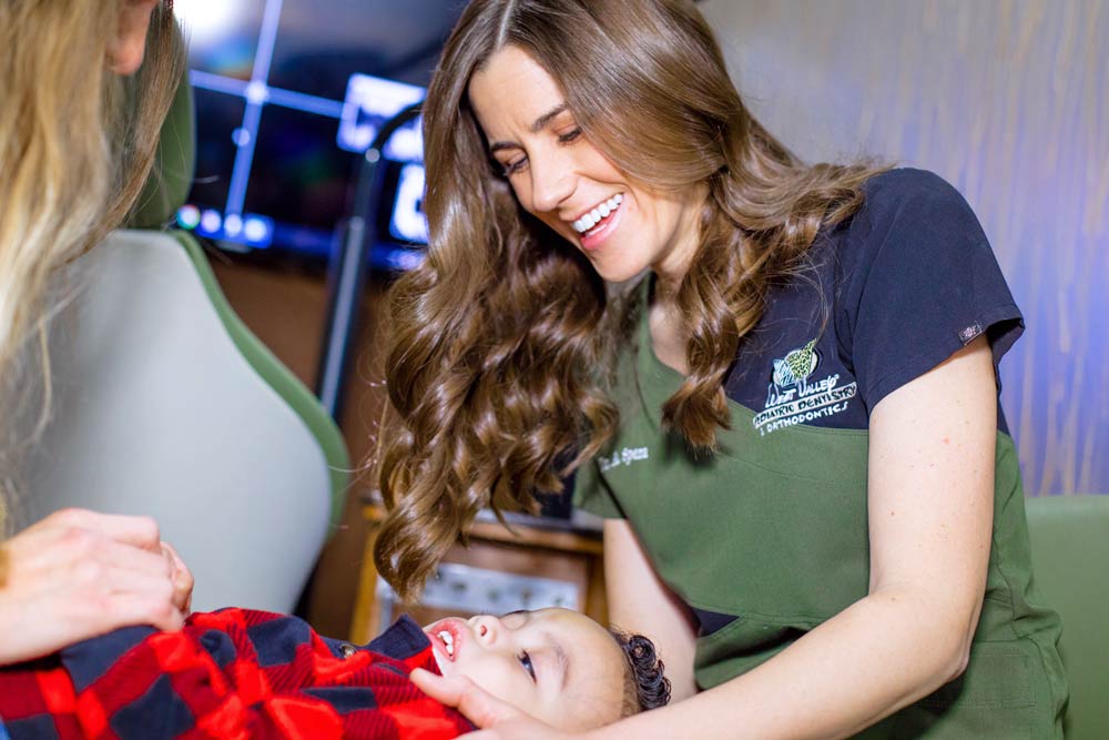 engaging dental photographer capturing orthodontist caring for child during photo shoot for pediatrics by olive branch ms professional danielle jacqueline