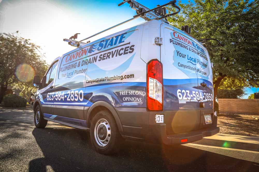 lower angle with lens flair sunlight glisten midsouth professional image of plumbing and drain cleaning van capture during morning near curb outside business by automobile photographer danielle jacqueline near memphis tn