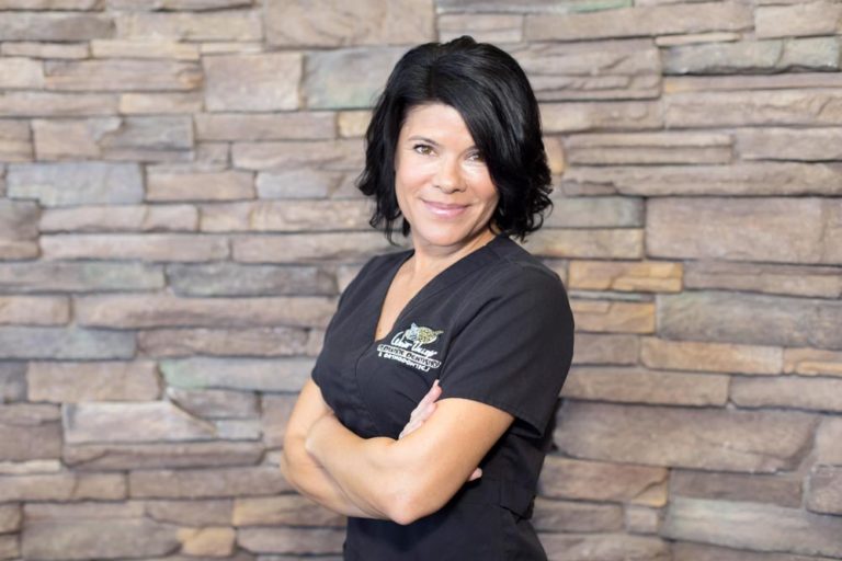 medical staff head shot for local dentistry for kids wearing black scrubs in front of stone wall by danielle jacqueline photography