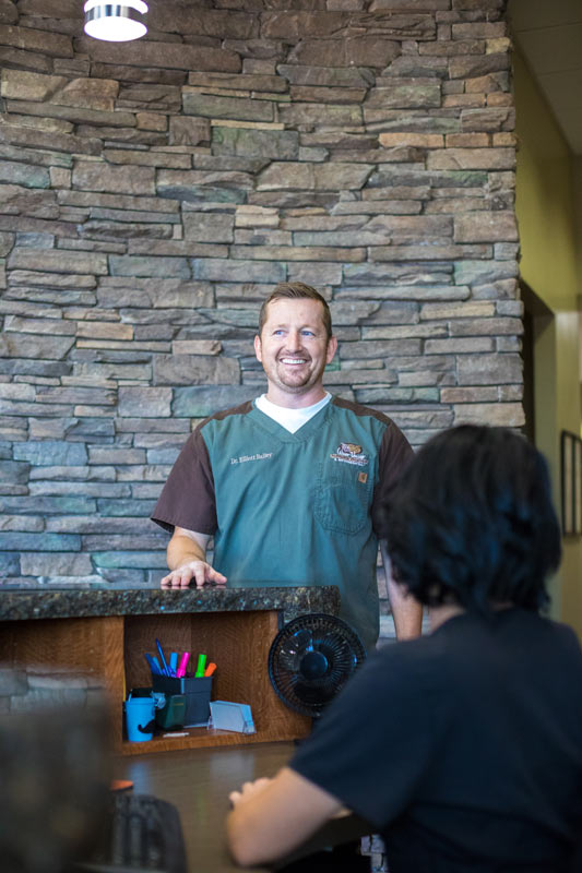 smiling business owner talking to front desk staff and laughing during company photo opp with danielle jacqueline who now services memphis tn area