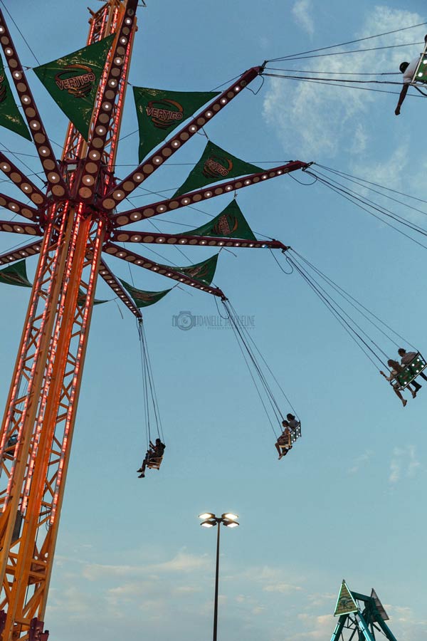 adult swings from below at dusk during southaven mississippi carnival event landers center attraction needing professional photography near olive branch ms