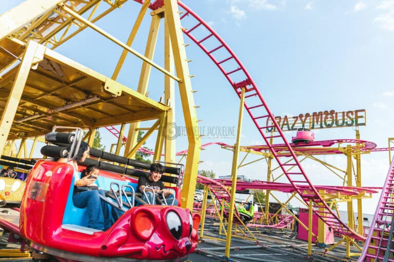 siblings riding crazy mouse roller coaster for kids ride at midsouth fair in southaven mississippi satruday events photographer danielle jacqueline lighting